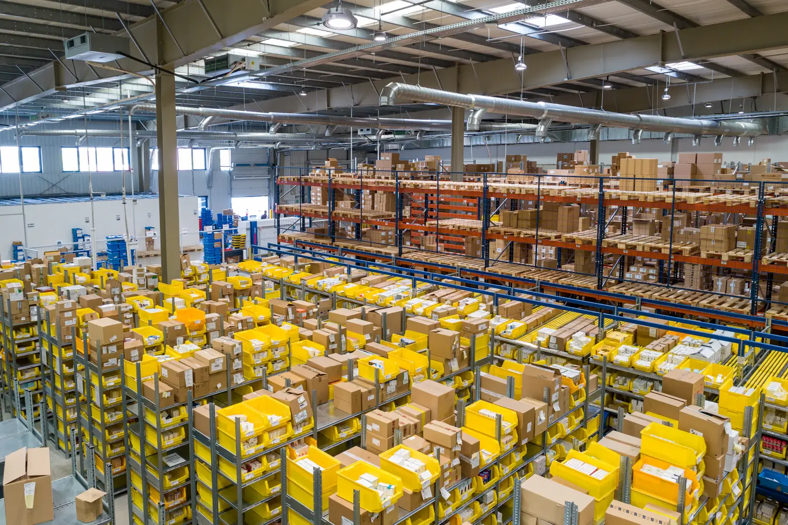 A wholesale distribution warehouse with racked pallets and order-picking bins